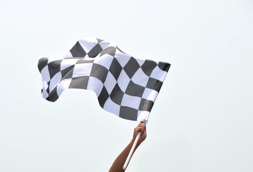 checkered race flag in hand