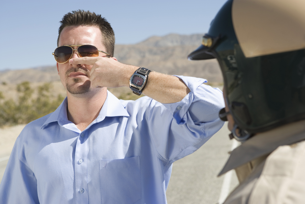 A visual representation of a field sobriety test being conducted by law enforcement, demonstrating the enforcement of DUI and OWI laws, especially when controlled substances are involved. 