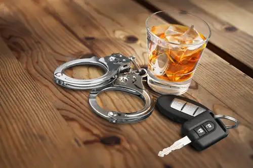 car keys, handcuffs, and glass of liquor