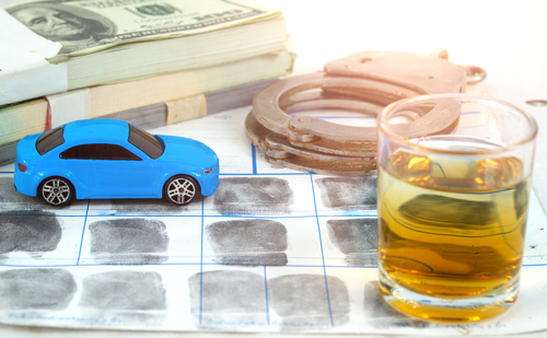 money, liquor, finger prints, toy car, and hand cuffs